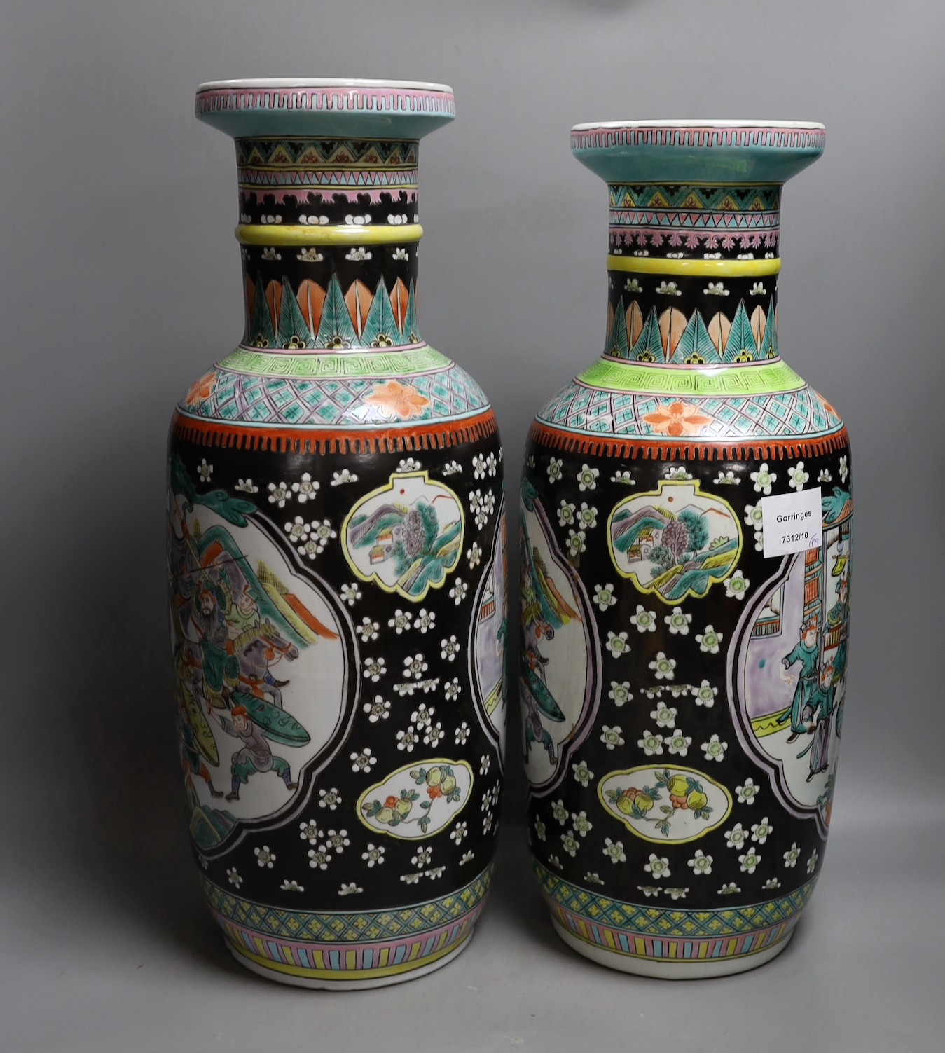 A near pair of Chinese black ground rouleau vases. 47.5cm high